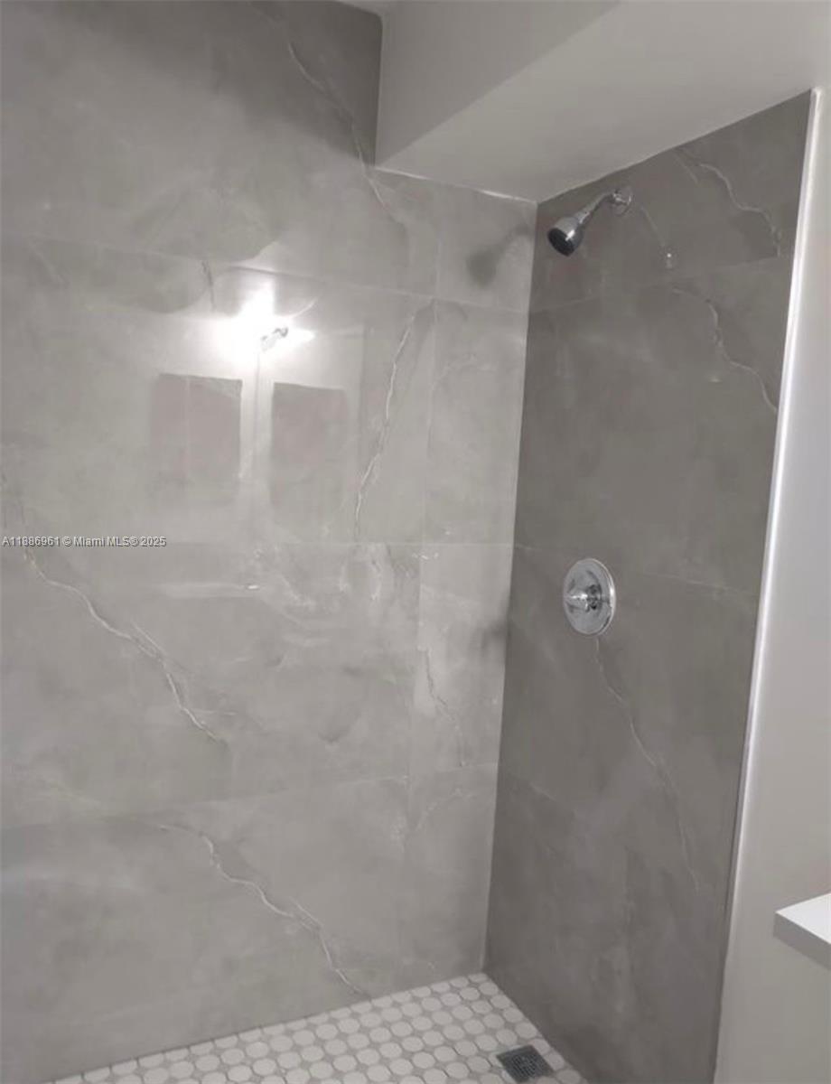 711 Lyons Road, Unit 14107 Coconut Creek, FL 33063 - Photo 3 of 24 a bathroom with a shower