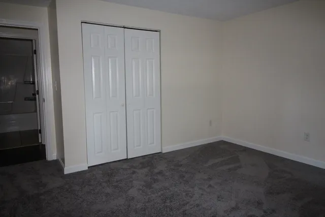 an empty room with closet area