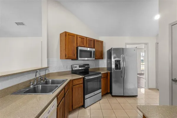 a kitchen with a sink cabinets and stainless steel appliances