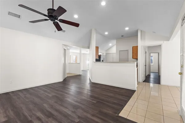 a view of a kitchen with a sink and a refrigerator