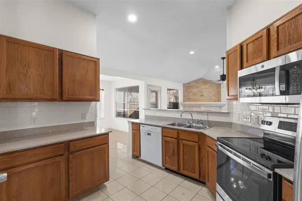 a kitchen with a sink stove and cabinets
