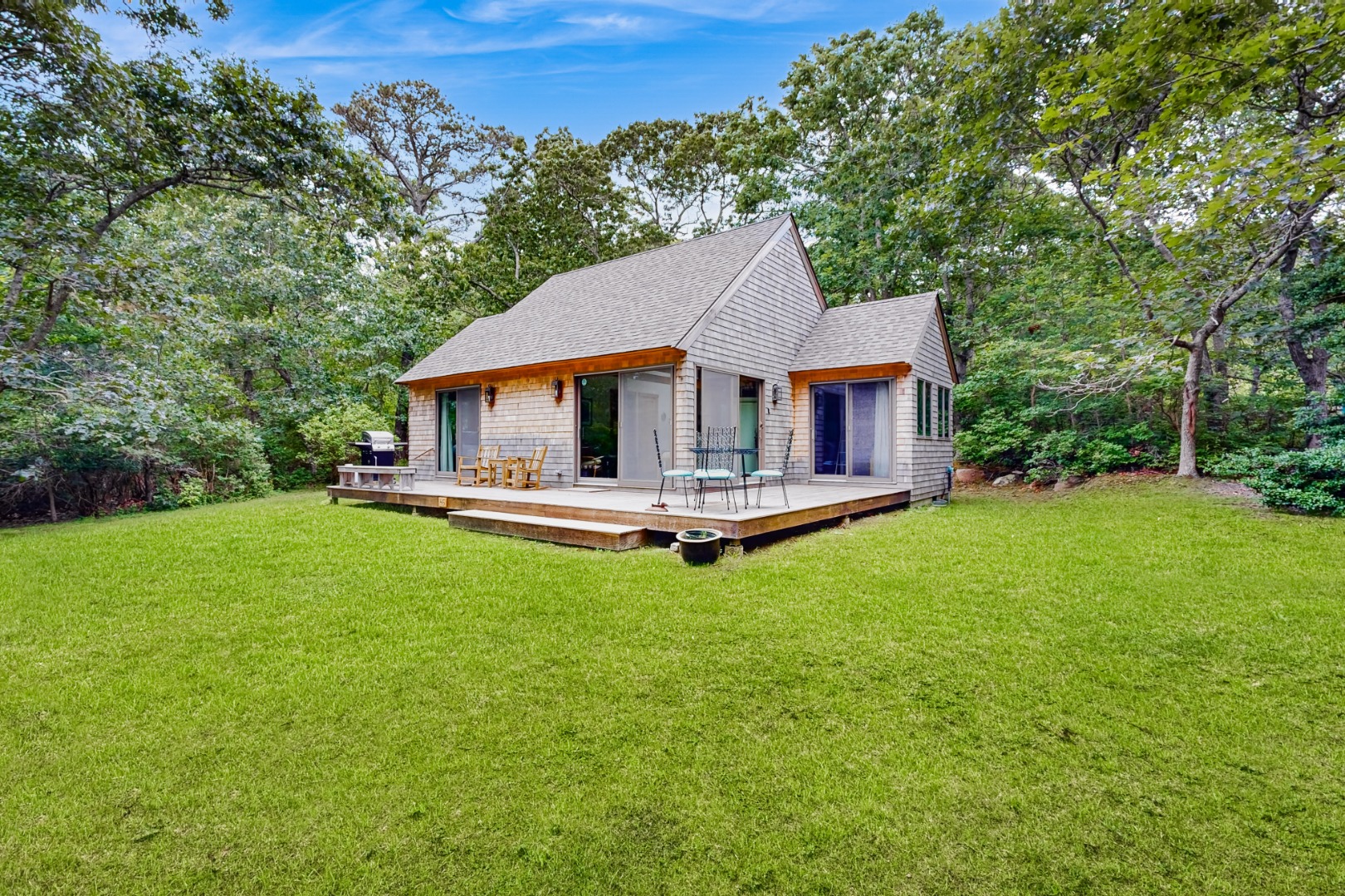 a house with green field in front of it