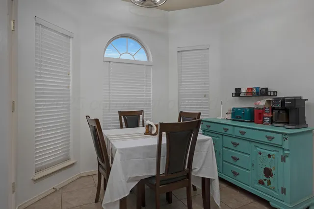 a dining room with furniture and a window