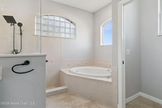 a bathroom with a tub sink and mirror