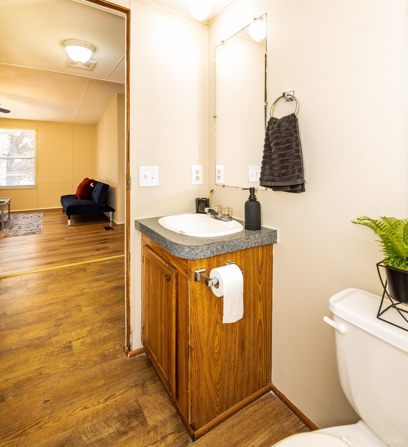 5893 Red House Road Appomattox, VA 24522 - Photo 12 of 28 a bathroom with a granite countertop sink and a mirror