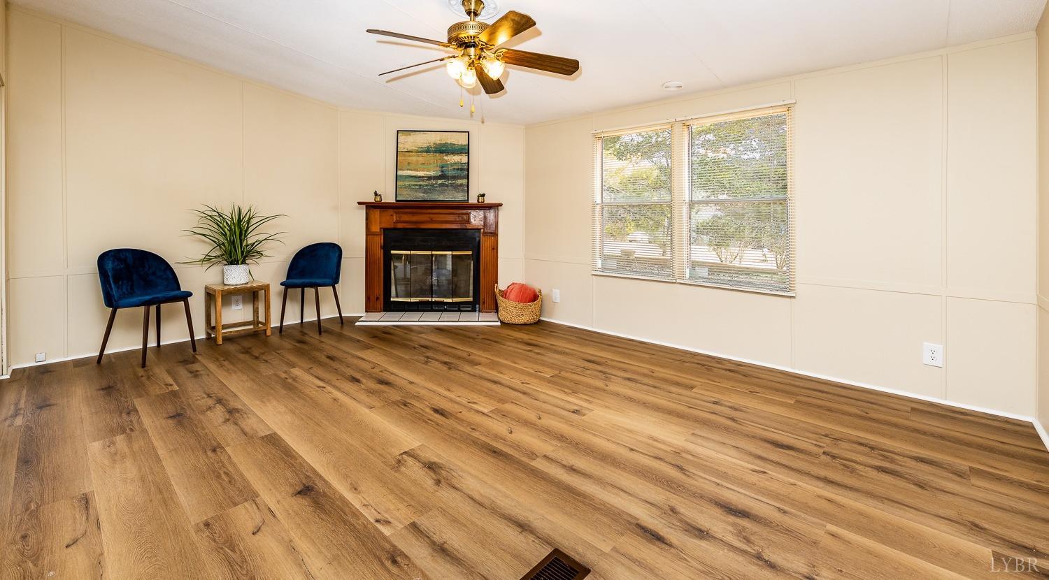 5893 Red House Road Appomattox, VA 24522 - Photo 20 of 28 a view of a livingroom with a chair and a potted plant