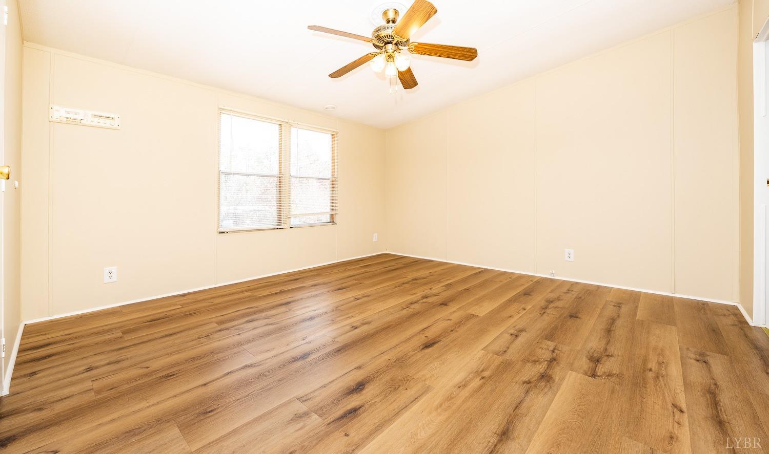 5893 Red House Road Appomattox, VA 24522 - Photo 10 of 28 a view of empty room with wooden floor and fan