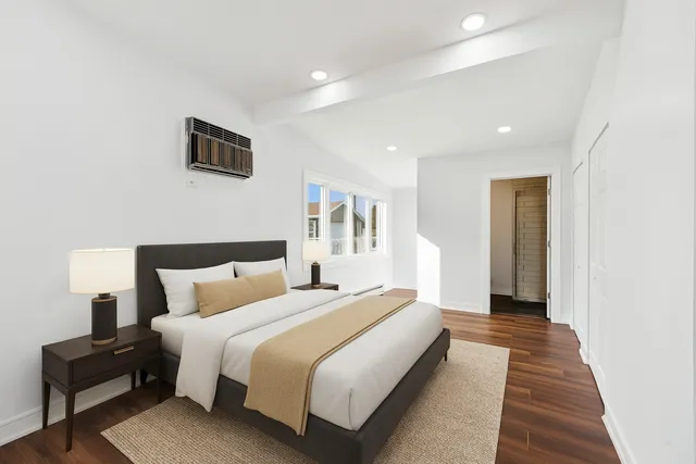 a bedroom with bed and a night stand