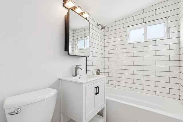 a bathroom with a sink a toilet and bathtub