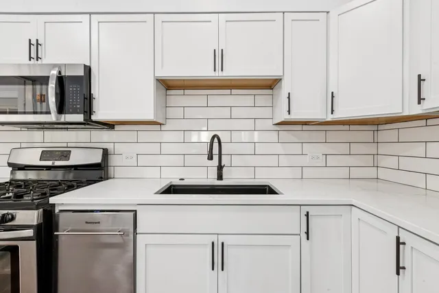 a kitchen with a sink and cabinets