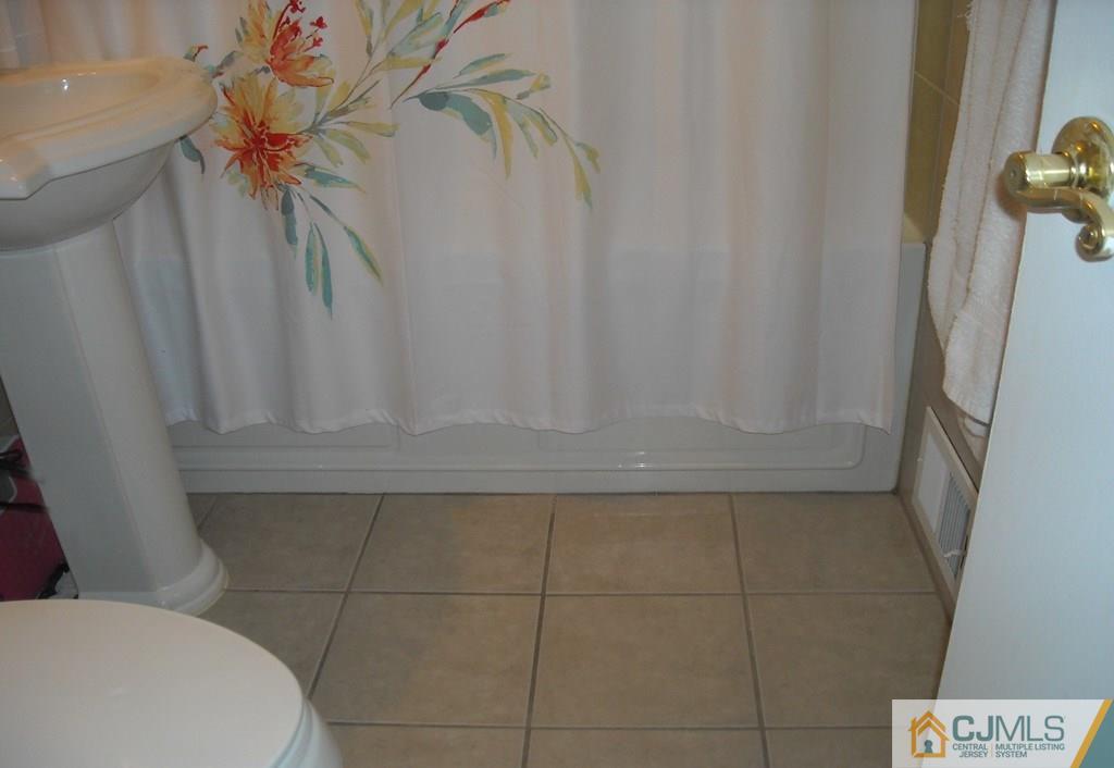 18 Gurley Road Edison, NJ 08817 - Photo 9 of 14 a bathroom with a sink and a mirror