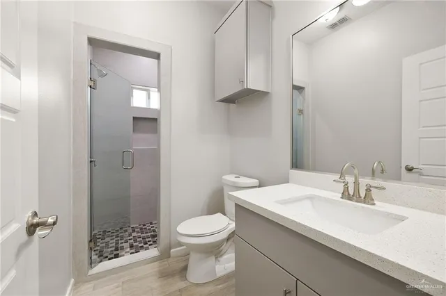 a bathroom with a sink toilet and shower