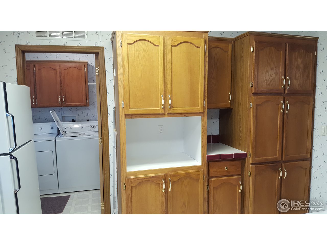 401 North Timberline Road, Unit 33 Fort Collins, CO 80524 - Photo 10 of 27 Abundant cabinets! Plus a peek @the laundry room.