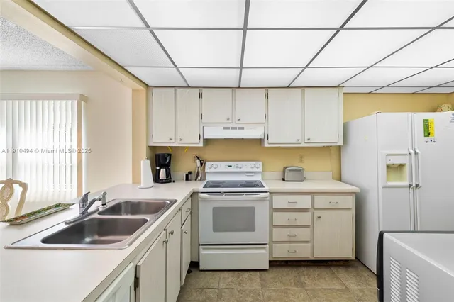 a kitchen that has a sink and a stove