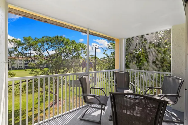 a view of a chair and tables in the balcony