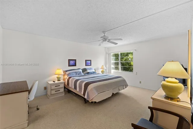 a spacious bedroom with a bed and a window