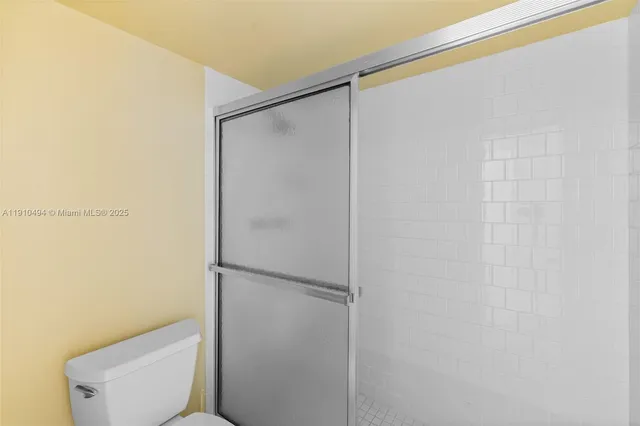 a bathroom with a toilet and a shower