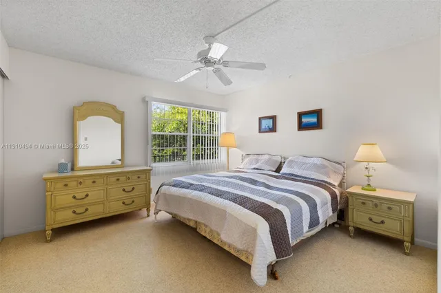 a bedroom with a bed dresser and a window