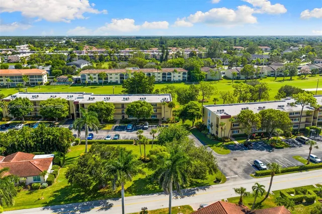 an aerial view of residential houses with outdoor space and street view