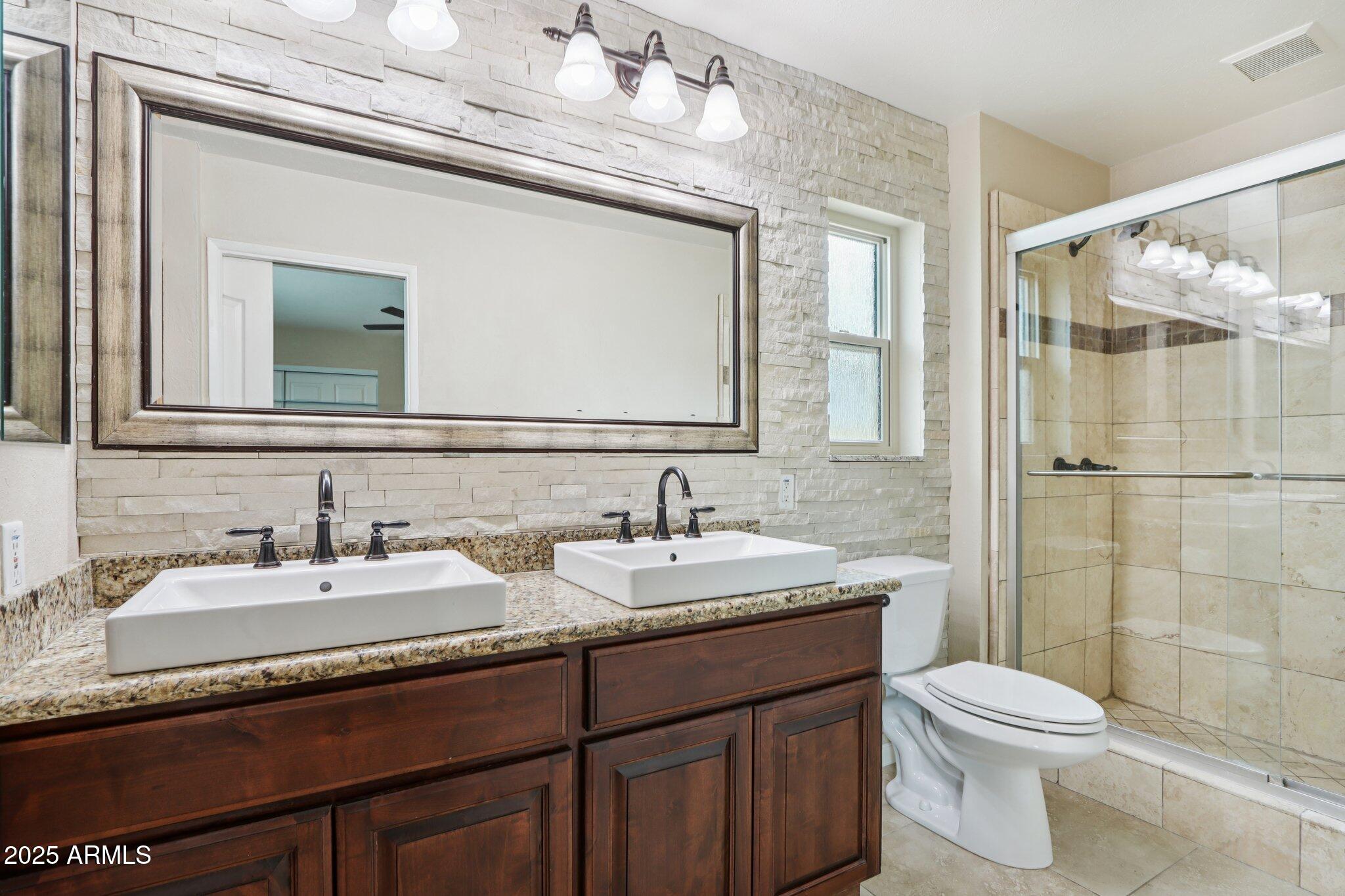 127 East Garfield Street Tempe, AZ 85288 - Photo 18 of 60 a bathroom with a granite countertop sink mirror and toilet