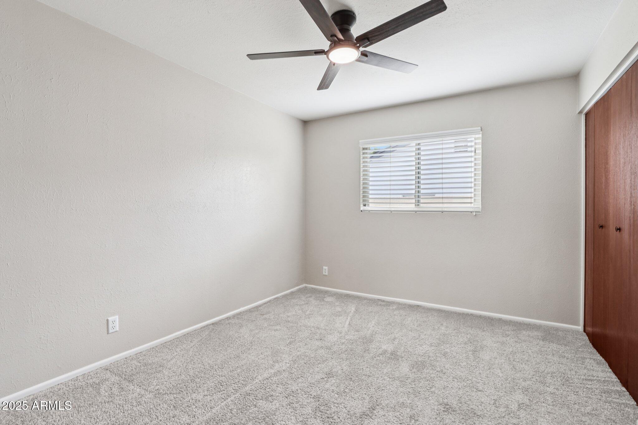 127 East Garfield Street Tempe, AZ 85288 - Photo 22 of 60 an empty room with a window and a fan