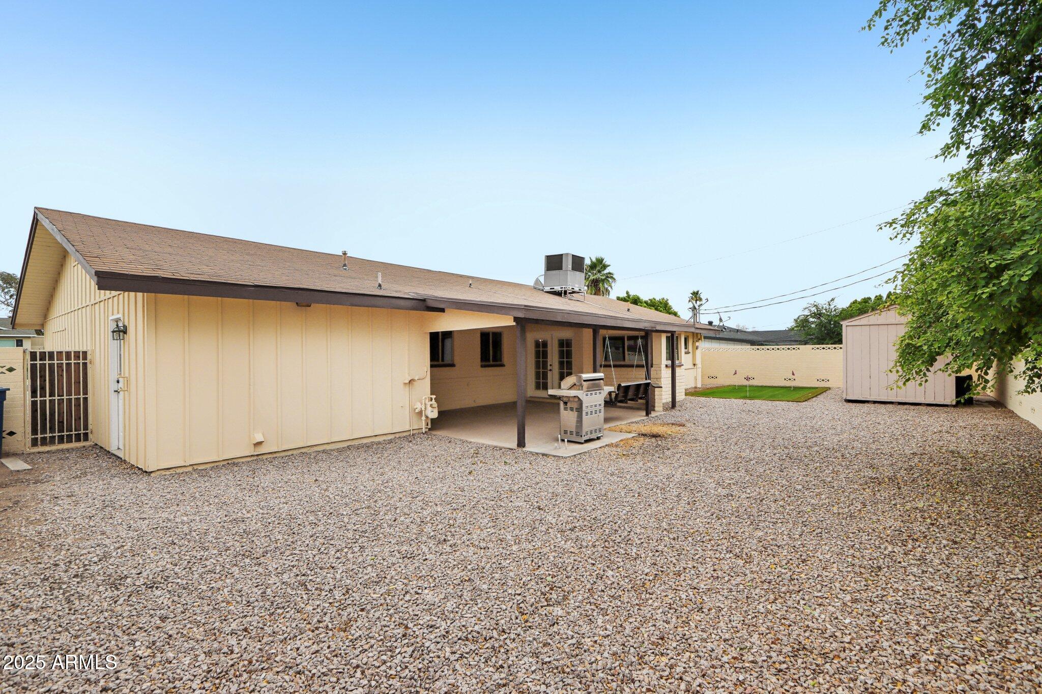 127 East Garfield Street Tempe, AZ 85288 - Photo 45 of 60 a view of a house with backyard space and a tree