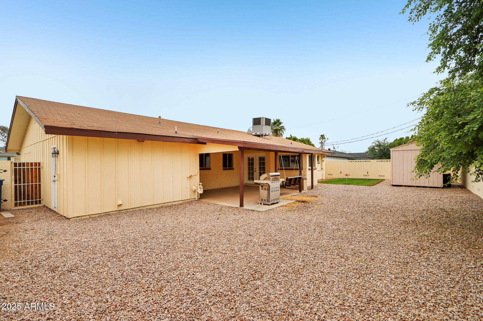 127 East Garfield Street Tempe, AZ 85288 - Photo 46 of 60 a view of a house with backyard space and a tree