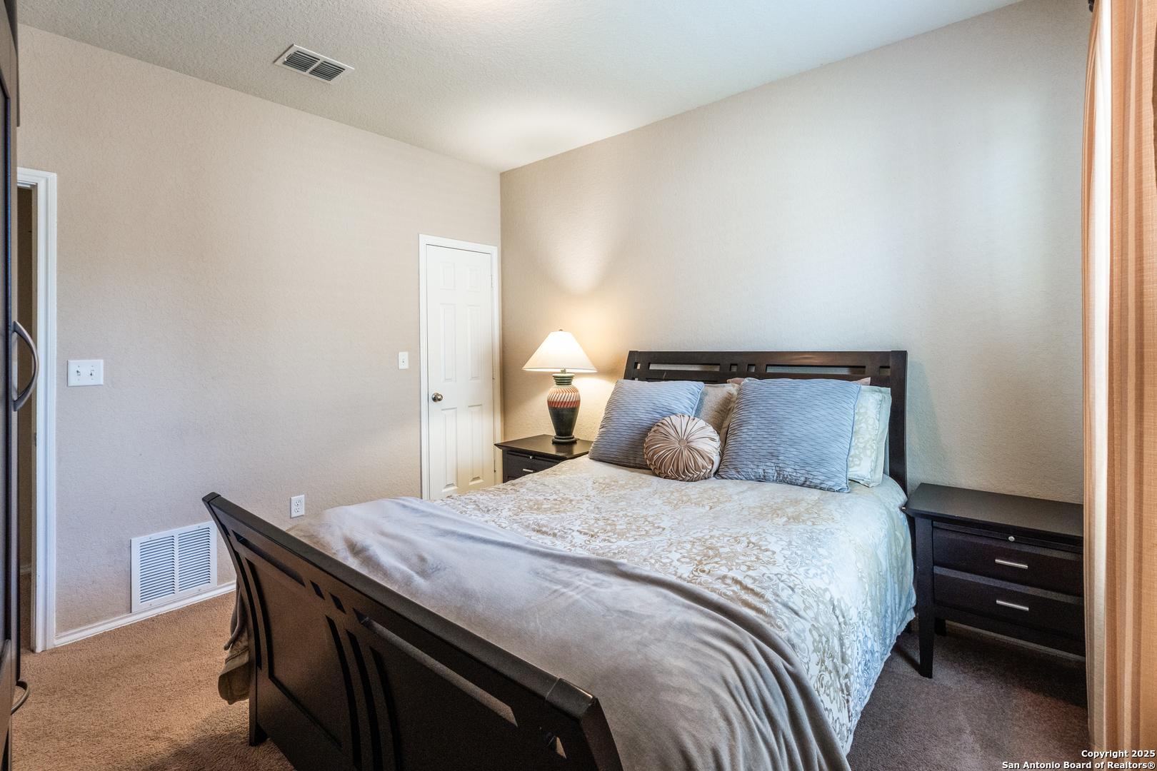 15923 Silver Rose Selma, TX 78154 - Photo 16 of 19 a bedroom with a bed and a night stand