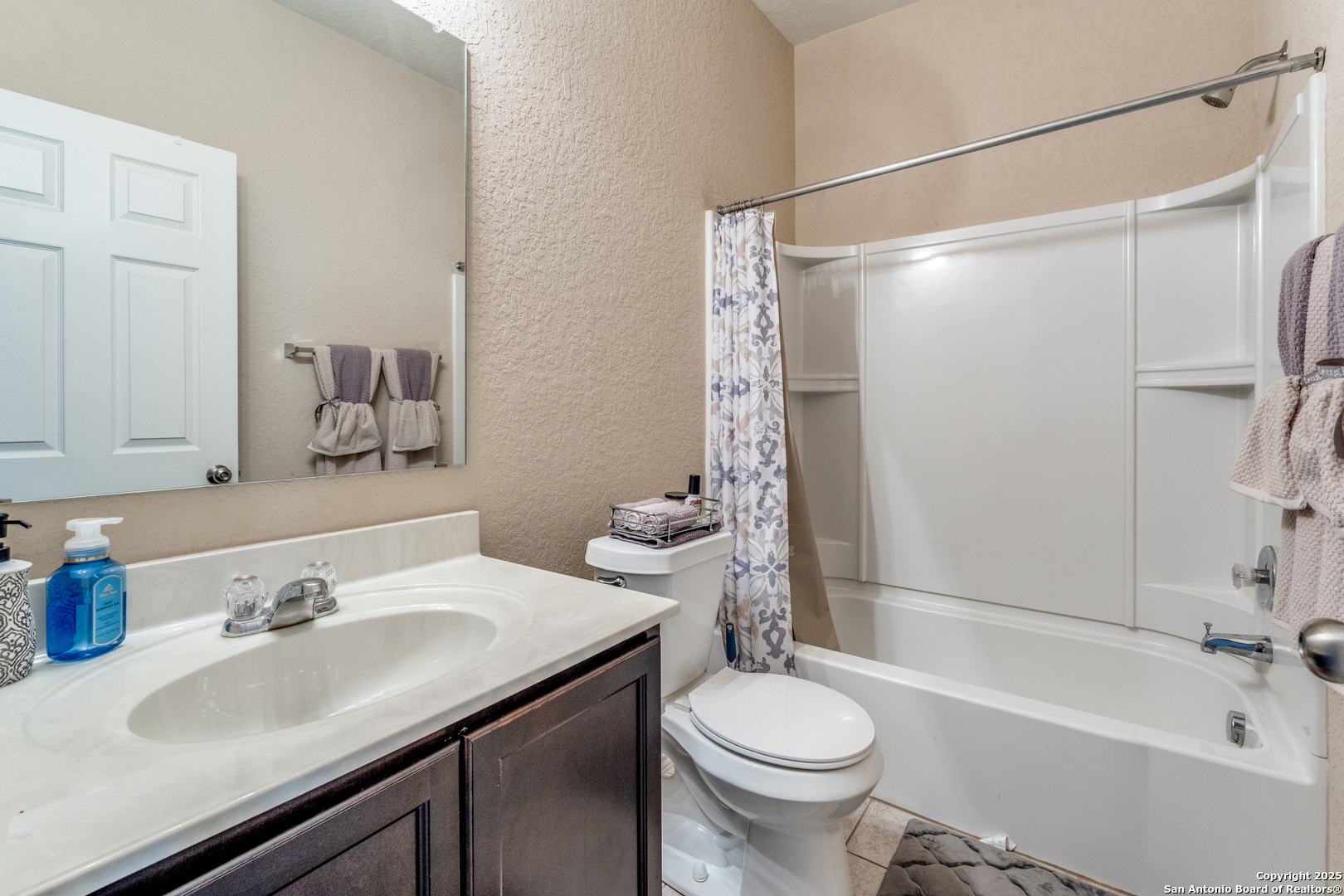 15923 Silver Rose Selma, TX 78154 - Photo 17 of 19 a bathroom with a sink toilet and shower