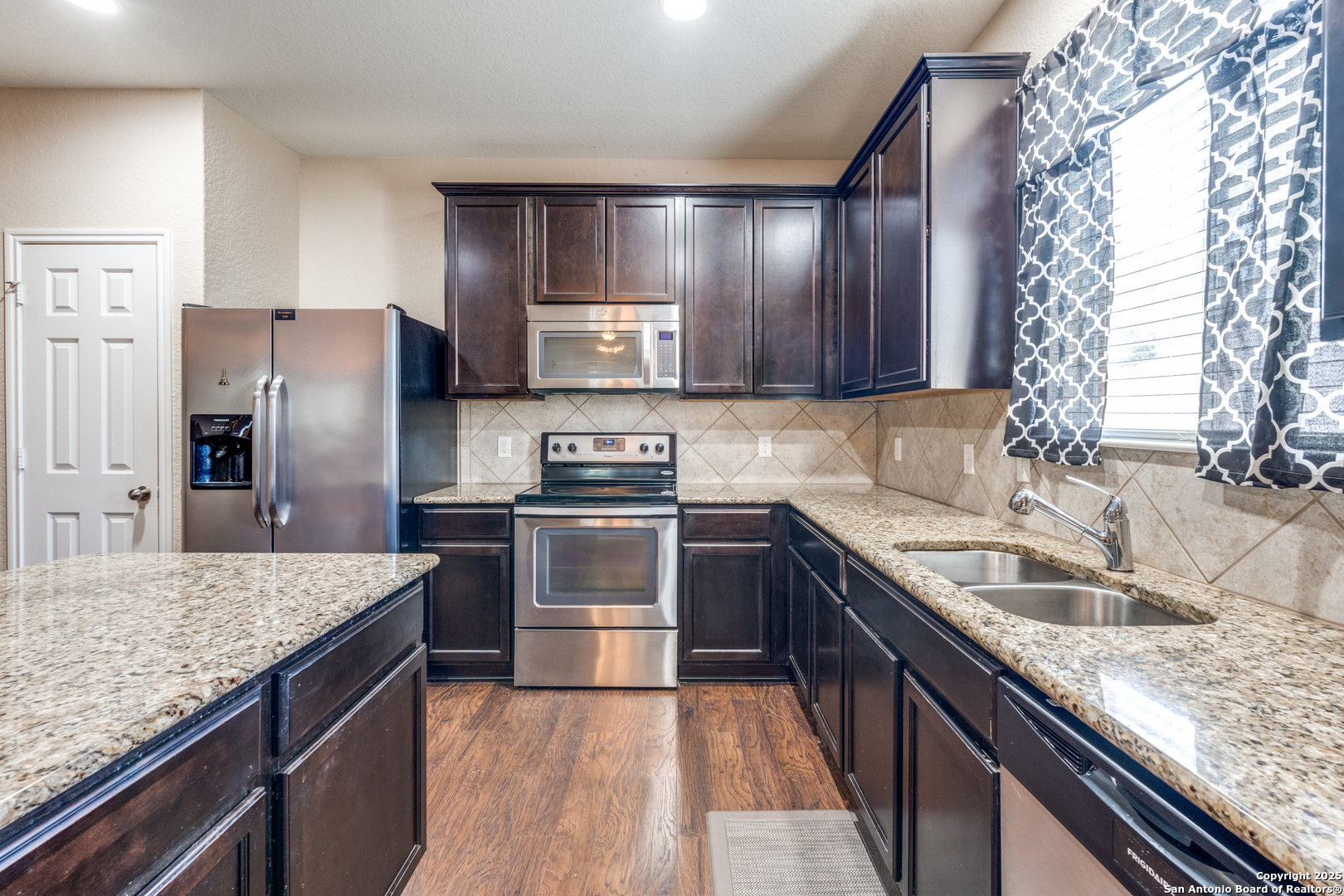 15923 Silver Rose Selma, TX 78154 - Photo 5 of 19 a kitchen with stainless steel appliances granite countertop a sink stove and refrigerator