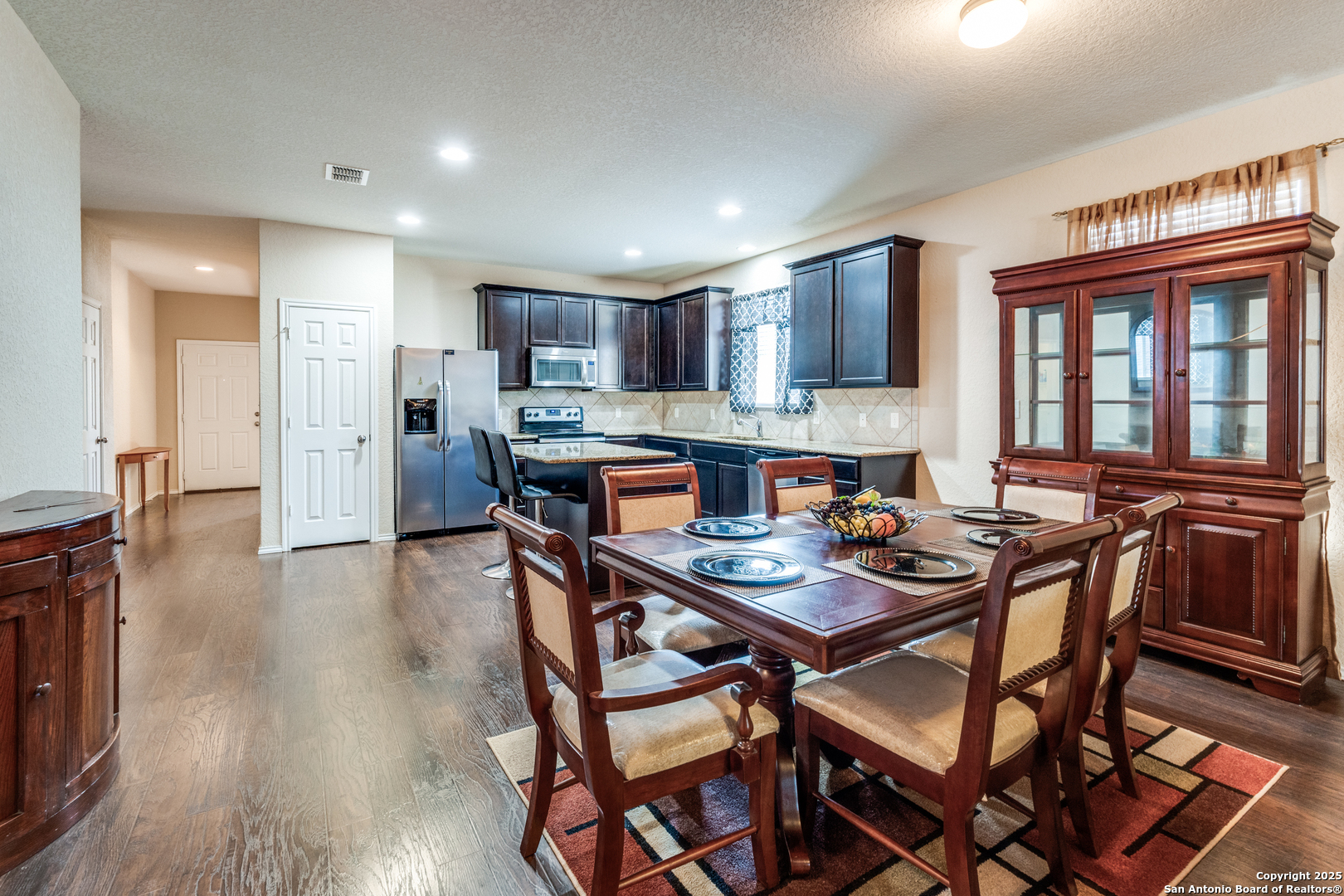 15923 Silver Rose Selma, TX 78154 - Photo 8 of 19 a dining room with stainless steel appliances a table and chairs