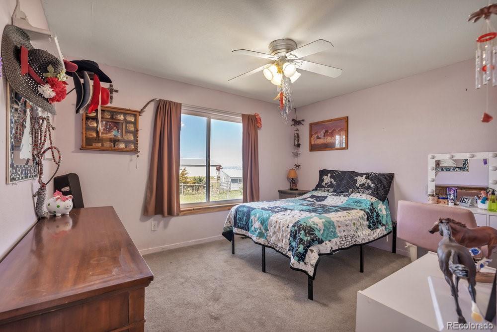 24535 County Road 5 Elbert, CO 80106 - Photo 21 of 45 a bedroom with a bed and a table