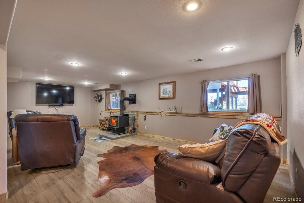24535 County Road 5 Elbert, CO 80106 - Photo 23 of 45 a living room with furniture and a flat screen tv