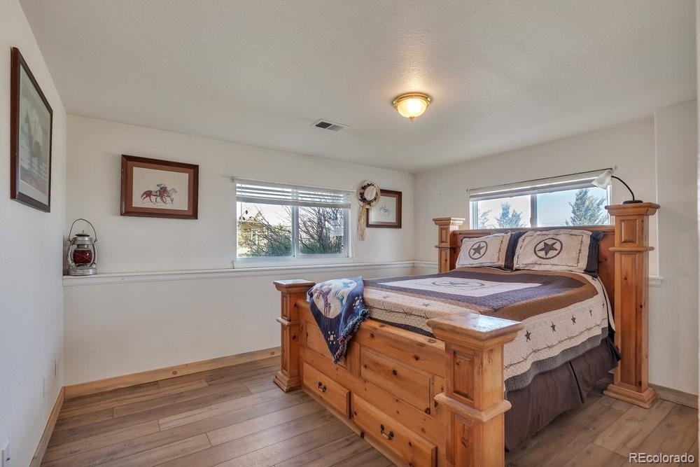 24535 County Road 5 Elbert, CO 80106 - Photo 26 of 45 a bedroom with a bed and wooden floor