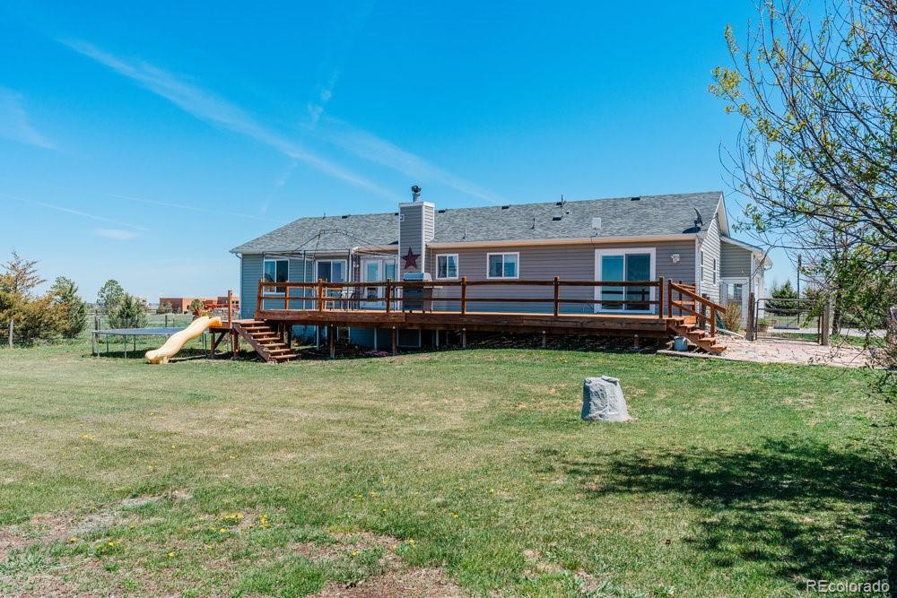 24535 County Road 5 Elbert, CO 80106 - Photo 31 of 45 a view of a house with a backyard and a patio