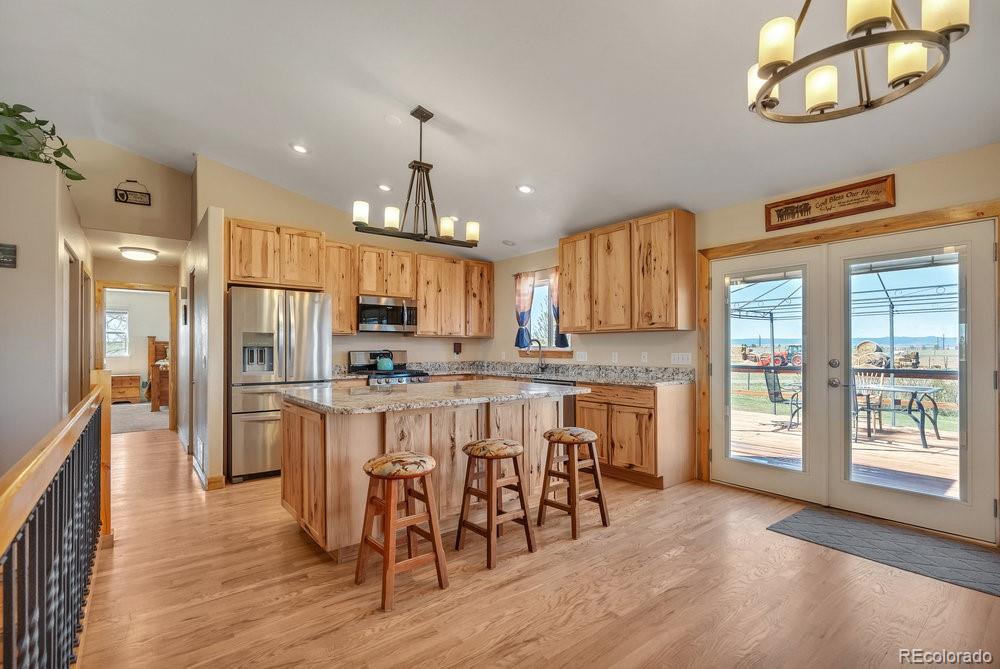 24535 County Road 5 Elbert, CO 80106 - Photo 5 of 45 a large kitchen with a table and chairs