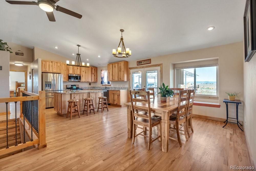 24535 County Road 5 Elbert, CO 80106 - Photo 8 of 45 a view of a dining room with furniture and wooden floor
