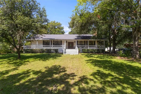 a view of a house with swimming pool and garden