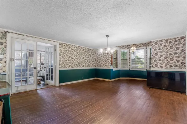 a view of a livingroom with furniture wooden floor a chandelier