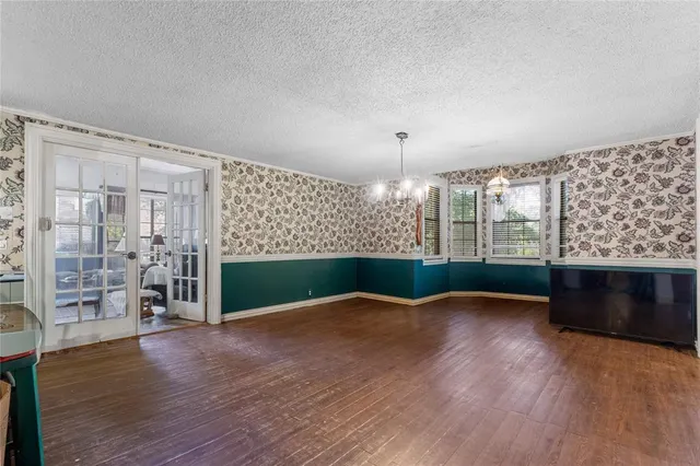 a view of a livingroom with furniture wooden floor a chandelier