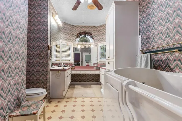 a bathroom with a sink toilet a mirror and shower