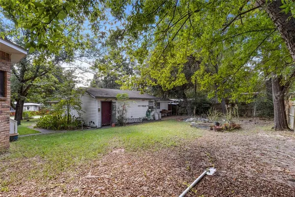 a view of a house with backyard and sitting area
