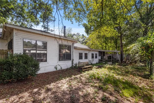 a view of a patio with a table and chairs under an umbrella