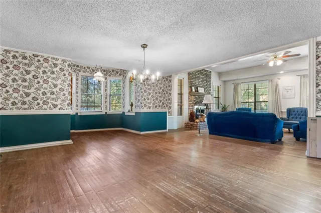 a living room with furniture a ceiling fan and a window