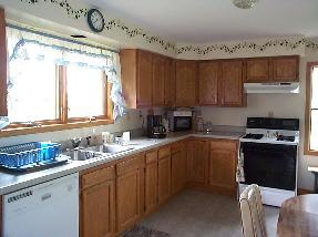 8951 Stillman Valley Road Stillman Valley, IL 61084 - Photo 5 of 5 a kitchen with a sink a stove a window and cabinets