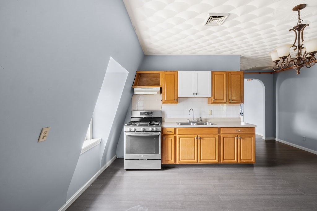 186 John Street Fall River, MA 02721 - Photo 18 of 38 a kitchen with stainless steel appliances granite countertop a sink and a stove