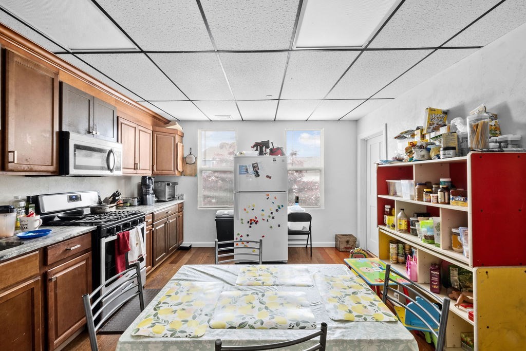 186 John Street Fall River, MA 02721 - Photo 26 of 38 a kitchen with stainless steel appliances granite countertop a stove and cabinets