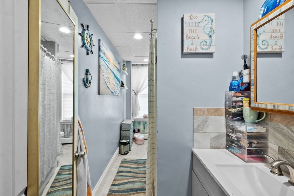 186 John Street Fall River, MA 02721 - Photo 30 of 38 a bathroom with a sink mirror and a shower