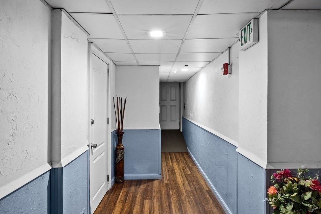 186 John Street Fall River, MA 02721 - Photo 37 of 38 a view of a hallway with wooden floor and stairs