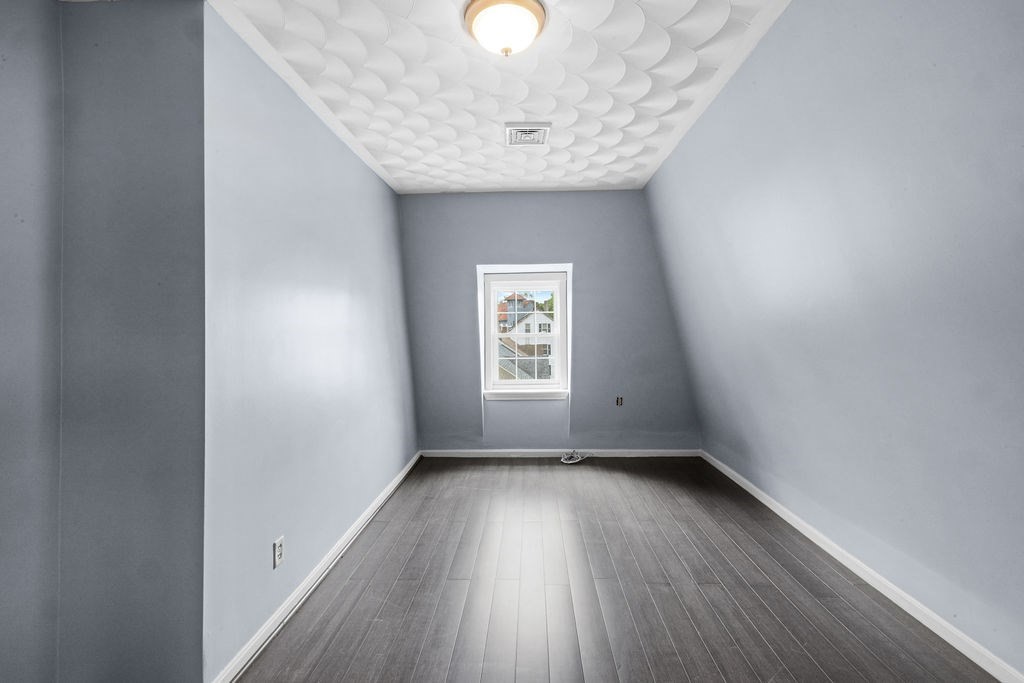 186 John Street Fall River, MA 02721 - Photo 10 of 38 an empty room with wooden floor and windows